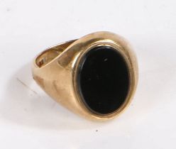9 carat gold ring set with an oval black stone to the head, ring size W weight 7.8 grams
