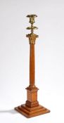 19th Century oak and gilt metal candlestick, the gilt sconce and a Roman Corinthian capital above