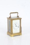 Gilt brass carriage clock, the white enamel dial with black roman numerals, the dial signed "
