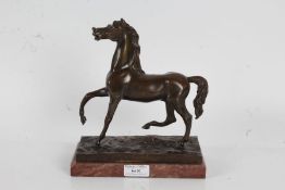 19th Century bronze horse, modelled with front and back right legs raised, on a marble plinth