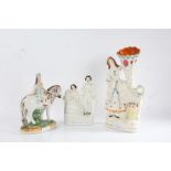 Three Victorian Staffordshire figures, to include a young girl on horseback, a cornucopia vase