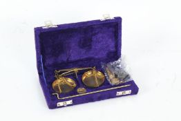 Cased set of balance scales, the brass scales with weights