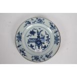 Chinese Kangxi blue and white porcelain plate, the central field with depiction of a table and
