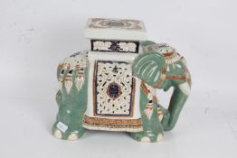 Large porcelain elephant decorated in middle eastern designs, with the saddle acting as a plinth,