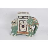 Large porcelain elephant decorated in middle eastern designs, with the saddle acting as a plinth,