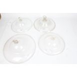 Four clear glass oil lamp smoke bells, the largest 30.5cm diameter (4)