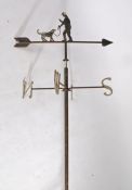 Metal weather vane, with a man with his dog, N.S.E.W. by blacksmith Graham Chaplin, 200cm long
