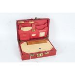Early 20th century red leather travelling case, the outer case with a red covering and red leather