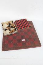 Red painted chess board, with roses, and a quantity of miniature wooden chess pieces, the board 45cm