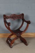 Italian Savonarola chair, the shell and scroll carved cresting rail above mythical beast carved