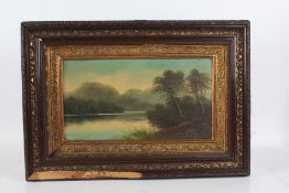 Victorian School, study of a lake and hills, unsigned oil, housed in a gilt decorated frame, 43cm