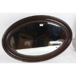 Mahogany framed oval wall mirror, having bevel edged glass plate, 82cm wide