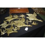 Collection of brass flying mallards, to include a set of three stamped "Geo. Johnson, England", (