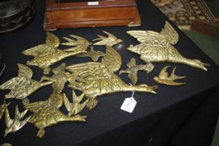Collection of brass flying mallards, to include a set of three stamped "Geo. Johnson, England", (