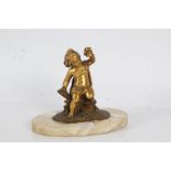 19th Century gilt bronze figure depicting a young boy seated on a log holding a small bird aloft, on