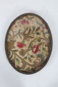 17th century needlework oval panel, embroidered with red flowers, gold stems and green leaves,