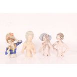 Four large porcelain half pin dolls, two with curled hair and two wearing hats, 12cm approx. (4)