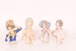 Four large porcelain half pin dolls, two with curled hair and two wearing hats, 12cm approx. (4)