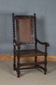 18th Century style elbow chair, the turned finials above a scroll carved cresting rail, cane back