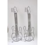 A pair of metal CD racks in the form of electric guitars.