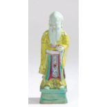 Chinese pottery figure, with bright yellow, green and blue glazed decorations standing on a