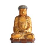 Fine Chinese gilt lacquered wood figure of Buddha, Ming Dynasty, the pointed hair whorls framing a