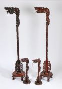 Set of four Chinese hardwood lamps, to include two standard lamps with dragon heads above a