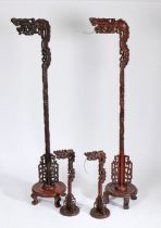 Set of four Chinese hardwood lamps, to include two standard lamps with dragon heads above a