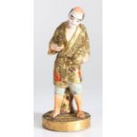 Japanese Satsuma earthenware figure, 20th Century, the standing figure with a basket in one hand,