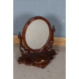 Victorian mahogany swing frame toilet mirror, the oval mirror with open scrolling supports, the