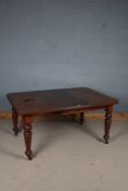 Victorian extending dining table, with chamfered corners, one extra leaf and winder, raised on tuned