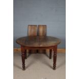 Victorian pull out extending dining table, the round ended top with two extra leaves, raised on