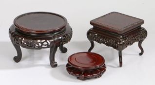 Three Chinese stands, the first example with a square top with an edge carved with bats and scrolls,