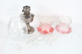 Pair of frosted and cranberry glass shades, with foliate decoration, together with a metal oil