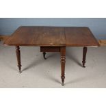 Victorian mahogany drop leaf table, the round cornered top raised on turned legs and brass