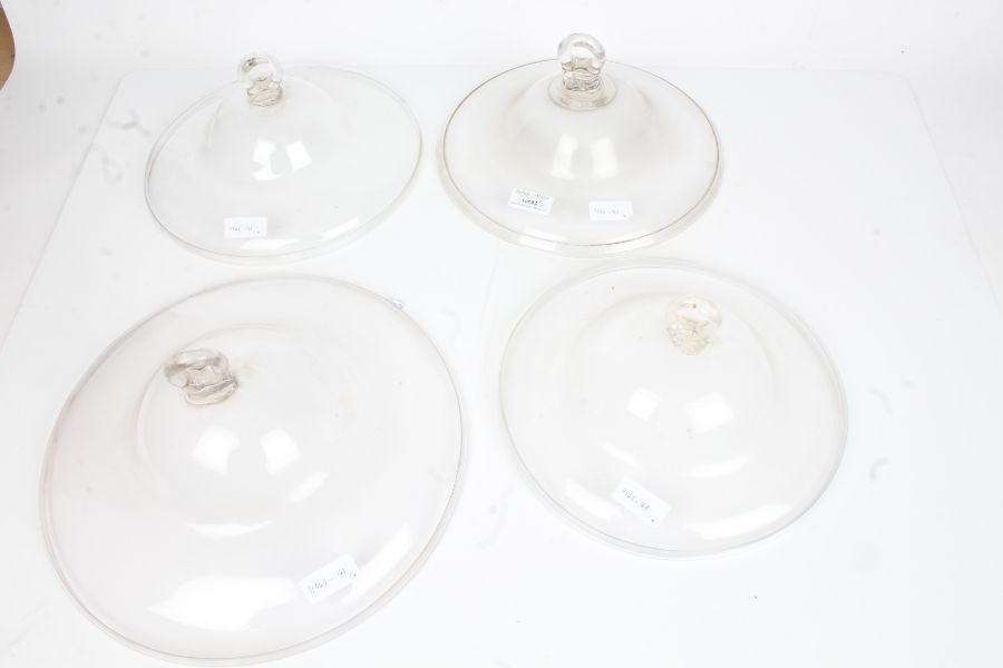 Four clear glass oil lamp smoke bells, the largest 30.5cm diameter (4)