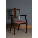 Edwardian marquetry inlaid elbow chair, the arched sunburst cresting rail above an urn and bow