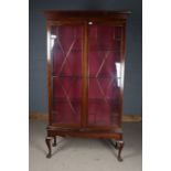 Edwardian mahogany display cabinet, with glazed doors opening to reveal glass shelves, raised on