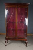 Edwardian mahogany display cabinet, with glazed doors opening to reveal glass shelves, raised on