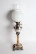 20th century silver plated and onyx oil lamp, having milk glass globular shade and chimney above a