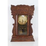 Late 19th/early 20th century American kitchen or mantel clock, having press moulded 'Gingerbread'