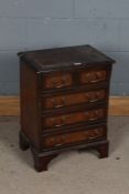 Mahogany effect chest of drawers, of small proportions, fitted short over three long drawers, 47cm