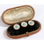 Three 18ct gold buttons with turquoise and mother of pearl. Weighing 5.7 grams. Encased in a leather
