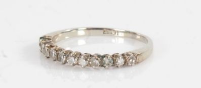 An 18ct white gold half eternity ring, Set with twelve diamonds, total approx. diamond carat