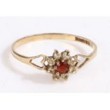 A 9ct gold ring set with a garnet and cubic zirconia and decorative heart shoulders. Ring size R.