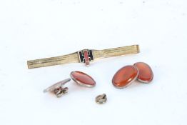 A rolled gold tie pin, a carved ivory elephant and a pair of round amber cuff-links. Gross weight
