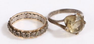 A 9ct gold and silver eternity ring, A central silver band with two outer 9ct gold bands. Weighing