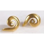 A pair of 18ct gold and diamond earrings in the form of swirl, with a diamond in each. Total approx.