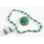 A set of white metal jade jewellery including a necklace, brooch and a pair of drop earrings.