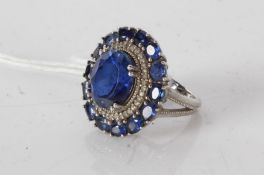 A silver ring set with synthetic sapphire. Ring size M. Weighing 7.7 grams.